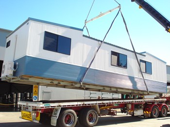 Relocatable home being put on the truck for delivery