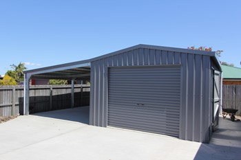 Single bay garage with carport attached in the color " Monument"